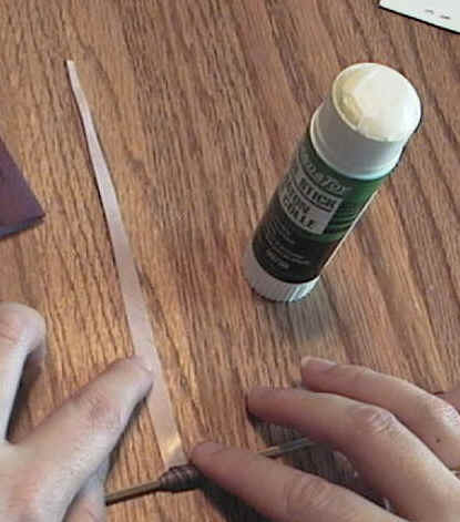 Roll the paper around the skewer.