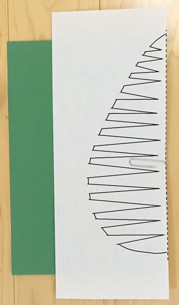 paper clip the template to a piece of construction paper